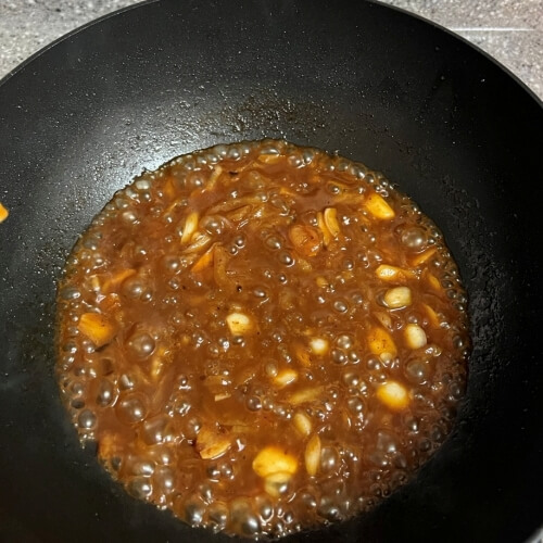 A flavorful A1 steak sauce simmering in a pan.