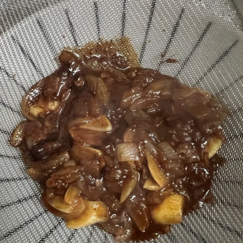 Finished A1 Steak Sauce being sieved and neatly prepared.