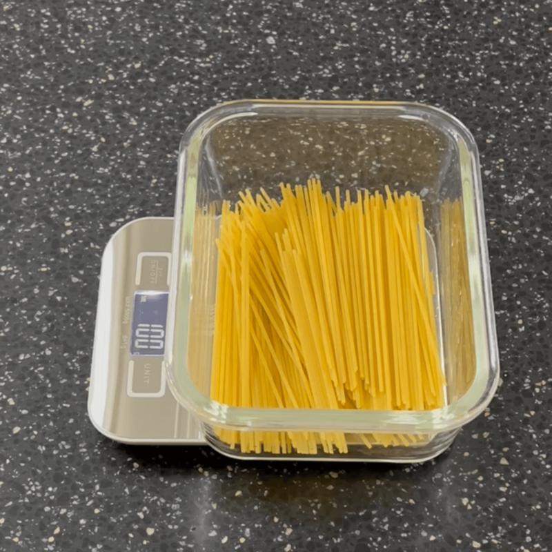 100 grams of broken pasta in a microwaveable bowl