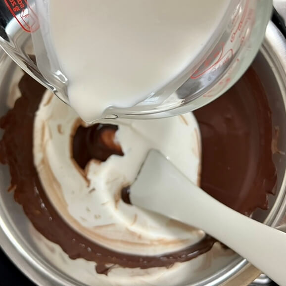 Folding whipped cream into melted chocolate