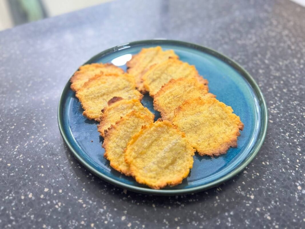 The sweet potato chip recipe is complete, with crispy sweet potato chips piled high in a bowl.