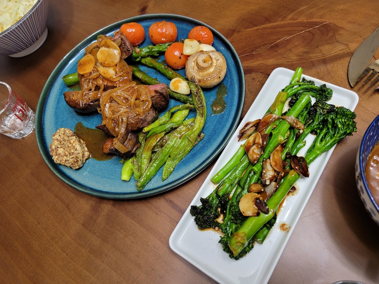 Finished broccolini stir-fry recipe, served with steaks