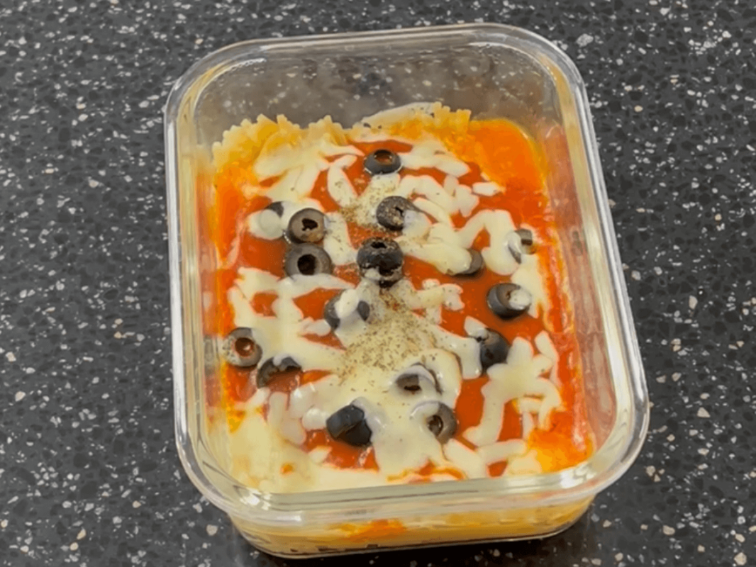 The finished tomato pasta in a microwaveable container with this super easy microwave pasta recipe.
