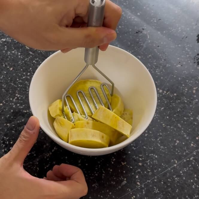 Mashing a steamed sweet potato