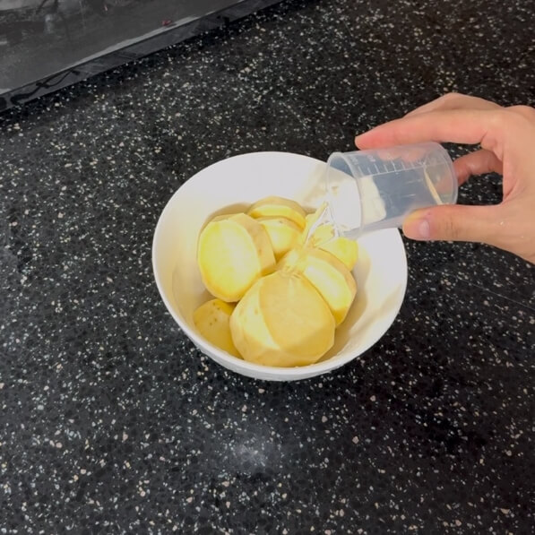 Adding water to the cut sweet potato
