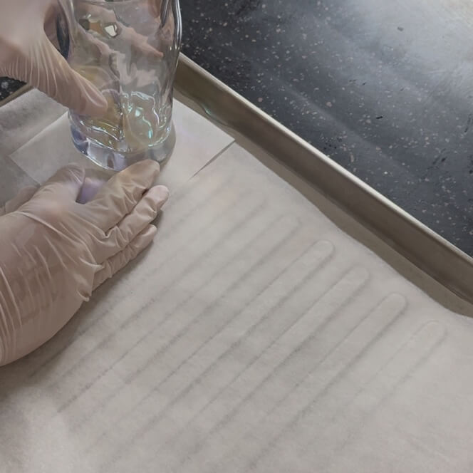 Pressing the dough into the bottom of the cup against the paper foil