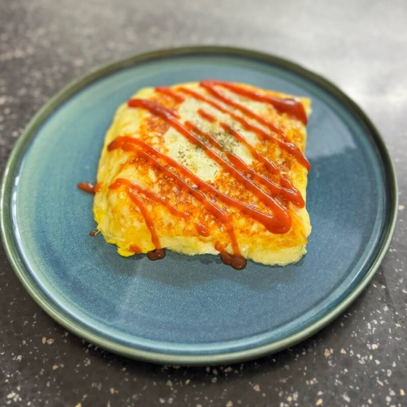 Finished toast with ketchup spread on it.