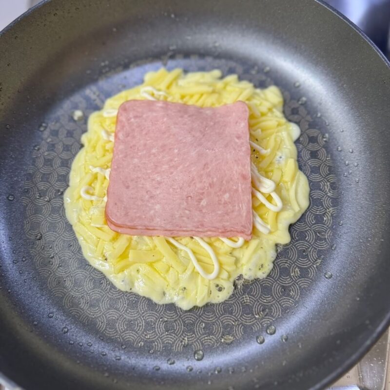 Ham on top of cheese and eggs
