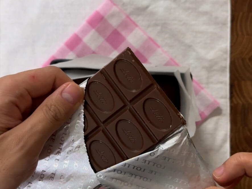 Unwrapping a bar of chocolate.
