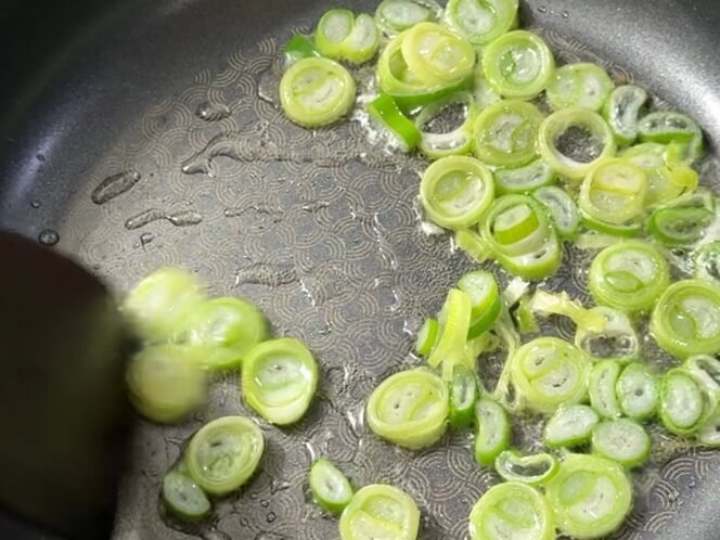 Turning up the heat and sautéing scallions