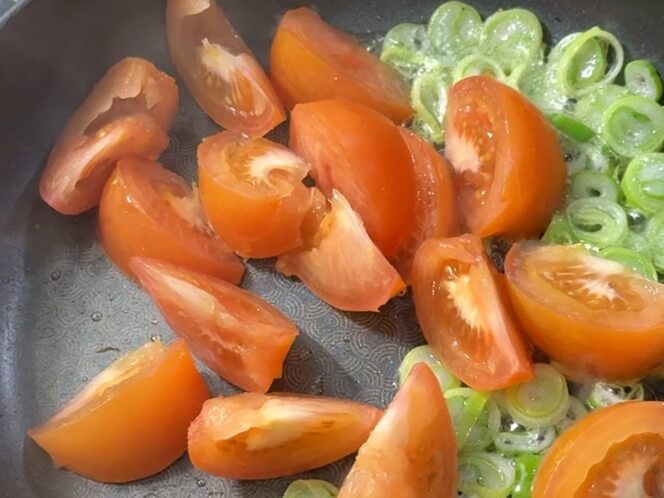 Tomatoes added to the pan