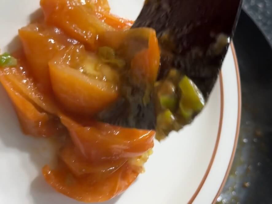 Transferring cooked tomatoes to a plate