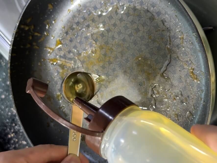 Adding cooking oil to a pan