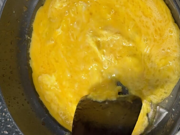 Whisking eggs to make scrambled eggs