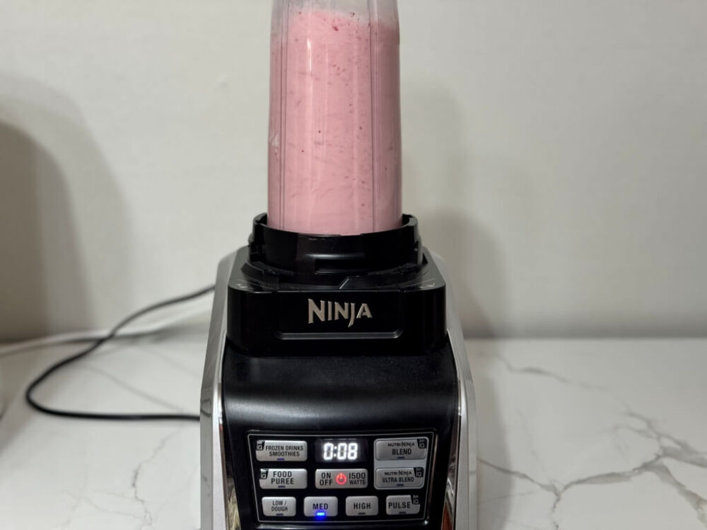 Grinding strawberries in a blender.