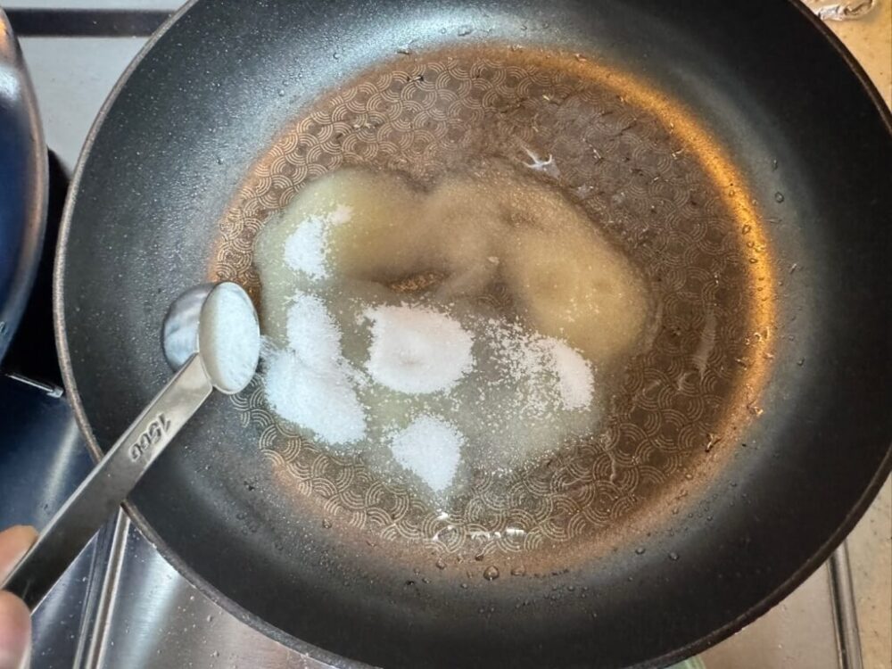 Sugar over a pan with oil