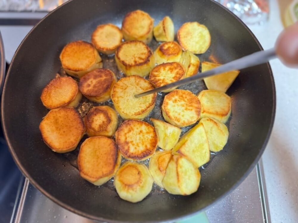Trying to poke a sweet potato with chopsticks.