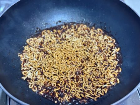 Simmering spaghetti in a pan