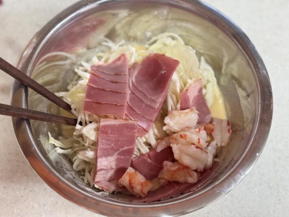 Bacon, shrimp, and cabbage added to the batter.