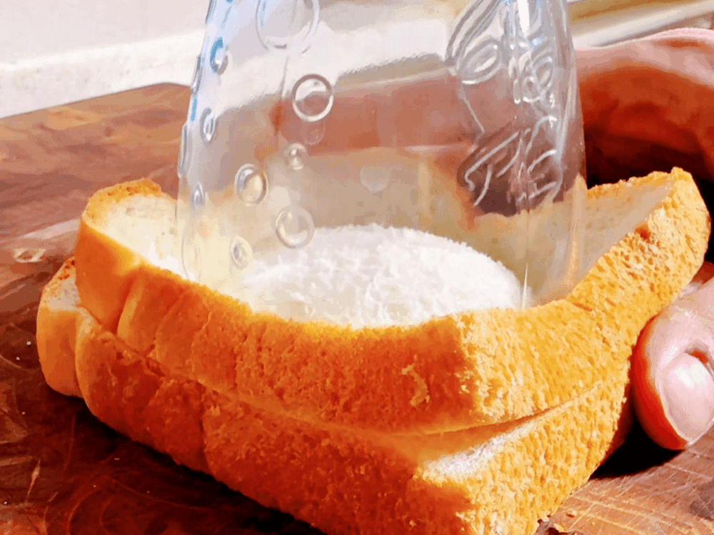 Pressing down on the center of the bread with a cup