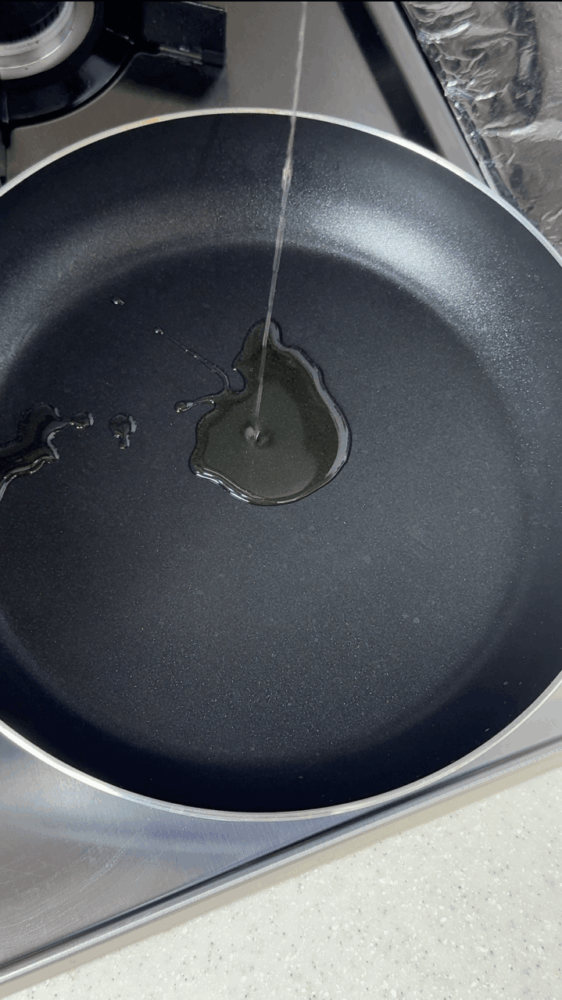 Pouring cooking oil into a skillet