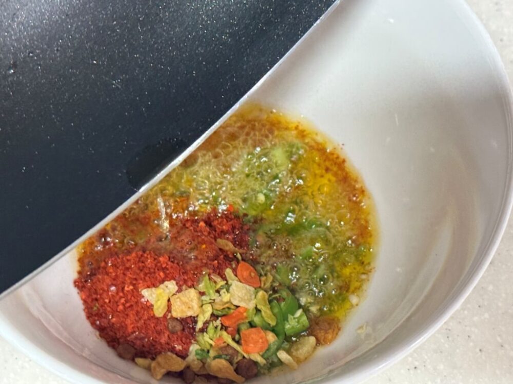 Adding hot olive oil to a bowl