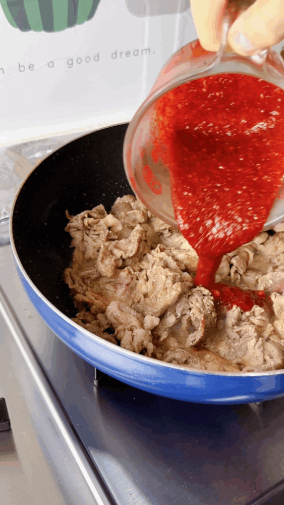 Pouring marinade over cooked pork