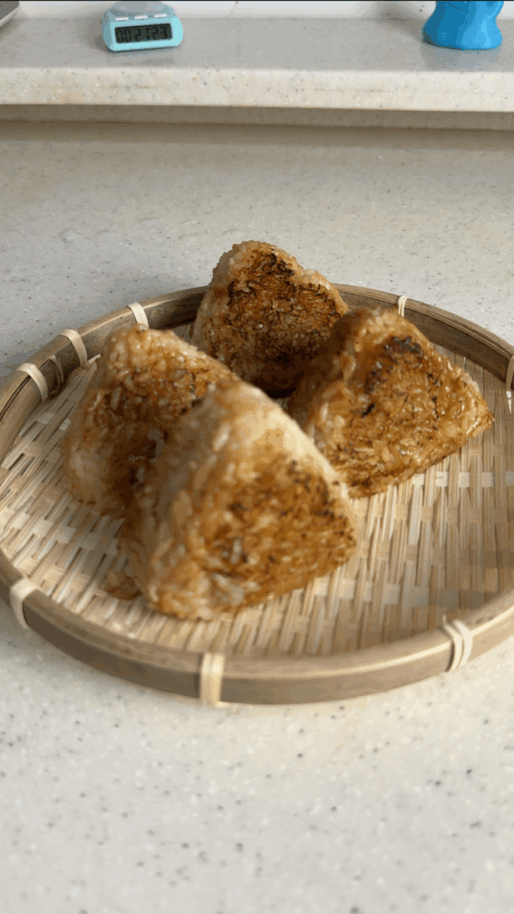 The finished grilled rice balls with miso sauce.