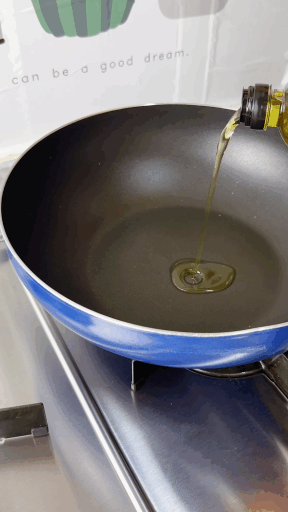 Adding cooking oil to a pan